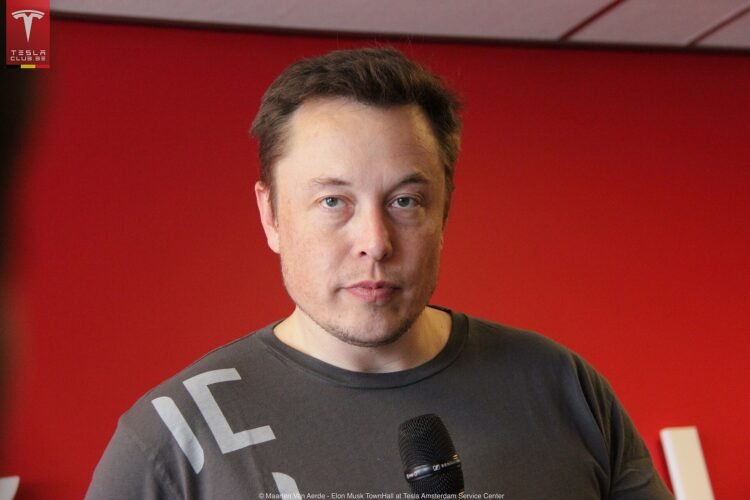 Elon Musk speaking at a Tesla event